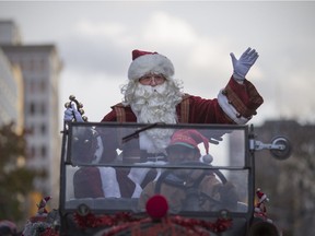 Santa Claus waves to the crowd during the Winter Fest Holiday Parade, Saturday, Nov. 19, 2016.