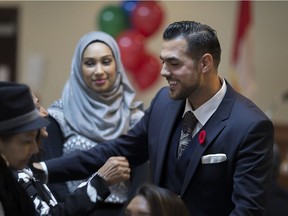 Adam Ibrahim, right, meets with supporters as he is acclaimed as the Windsor-West PC candidate at the Royal Canadian Legion branch 143, Saturday, Nov. 5, 2016.