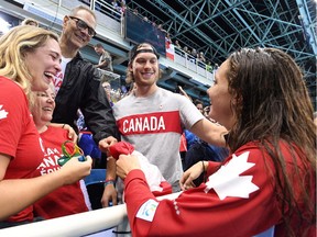 Canada's Penny Oleksiak celebrates her gold-medal win with family, including her brother, Dallas Stars' Jamie Oleksiak, second from right, in the women's 100m freestyle finals during the 2016 Olympic Summer Games in Rio de Janeiro, Brazil, on Friday, Aug. 12, 2016.
