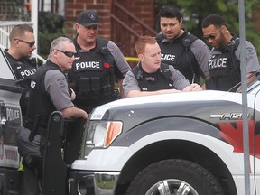 Officers with the Windsor police tactical unit investigate the scene of a "major crime incident" on Curry Avenue on Wednesday, Nov. 2, 2016.