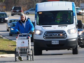 Joe Roberts pushes a shopping cart into Kingsville on Nov. 22, 2016. He is pushing a shopping cart 9,000 km across Canada to raise awareness and funds to help end youth homelessness.