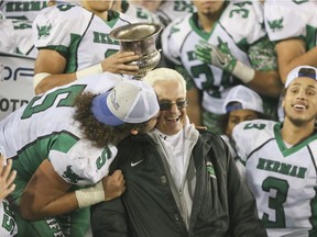Herman's Quintin Seguin celebrates the team's OFSAA win with a big kiss on the cheek of head coach Harry Lumley. The Green Griffins won their fifth straight provincial title on Nov. 30, 2016 at Tim Hortons Field in Hamilton.
