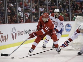 Detroit Red Wings center Riley Sheahan (15) controls the puck next to Montreal Canadiens defenseman Alexei Emelin (74) during the second period Saturday, Nov. 26, 2016, in Detroit.