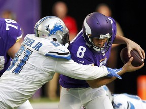 Minnesota Vikings quarterback Sam Bradford (8) is sacked by Detroit Lions defensive end Kerry Hyder, left, during NFL action in 2016.