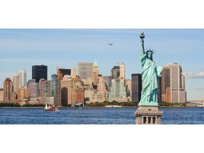 The landmark Statue of Liberty against the New York City skyline. Photo by Getty Images.