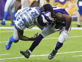 Detroit Lions safety Tavon Wilson is shown tackling Minnesota Vikings wide receiver Stefon Diggs, right, in 2016. The Lions inked Wilson to a new contract on Tuesday.