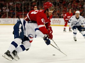 Darren Helm (43) of the Detroit Red Wings takes from Nikita Nesterov (89) of the Tampa Bay Lightning during the third period of an NHL game at Joe Louis Arena on Nov. 15, 2016 in Detroit, Mich. Tampa Bay won the game 4-3.