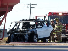 A burnt out Jeep Cherokee remains at the scene of an accident that involved a farm grain wagon on Highway 3 east of the Sexton Side Road in Tecumseh on Nov. 9, 2016.