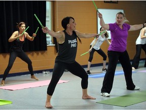 Using Ripstix, Suzie Vidinovski, centre, puts her students through a Pound Rockout workout at Tecumseh Arena recently.