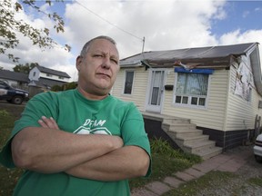 Greg Tremblay, 57, is pictured in front of his home at 3252 Riberdy Rd., Nov. 4, 2016.  Tremblay's home was damaged in this summer's tornado and he's now having issues with his insurance provider.