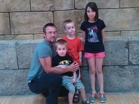 Adam Pouget and three of his children are pictured in this handout photo.