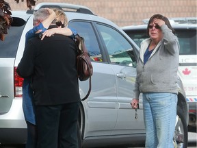 Distraught individuals are shown at Ventra Plastics in Windsor on Nov. 3, 2016, where a man fell through a skylight and suffered serious injuries.