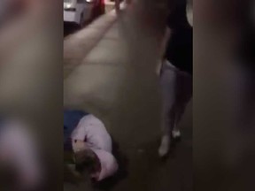 An image from a viral video that showed a group of Windsor teenagers verbally abusing, striking, and shoving another female teen.