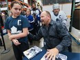 Former National Hockey League player Wendel Clark signs 12 year-old Jaycie Granger's shirt during an appearance at the Costco in Windsor on Wednesday, November 9, 2016 where his book Bleeding Blue: Giving My All for the Game was being sold.
