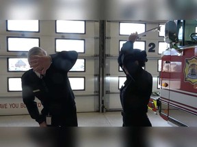 Windsor Fire Chief Bruce Montone avoids a clipboard pummelling in a screen grab from the Windsor Fire & Rescue Services Mannequin Challenge video.