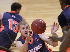 Island Storm's Nick Evans, centre, battles for a loose ball against the Windsor Express during a NBL Canada basketball game at WFCU Centre on Nov. 13, 2014.