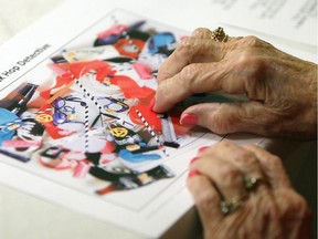 A woman works on a puzzle at the Alzheimer Society of Windsor and Essex County in Windsor on March 10, 2015.