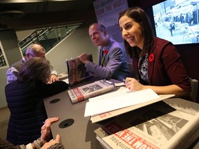 Authors Craig Pearson and Sharon Hanna sign copies of the latest From the Vault book during a book launch in the Windsor Star News Cafe in Windsor on Nov. 10, 2016.