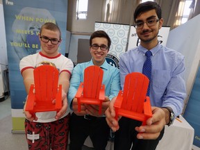 Vincent Massey students Michael Lachance, left, Storm Ricciotti and Gursimmer Banwait display the mini chairs they created for the FINA swim meet in Windsor on Nov. 17, 2016. The chair will be used as medal holders and presented to the medal winners.