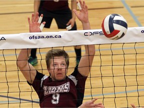 Leamington District High School's Daniel Warkentin tips the ball over the net against Stratford Central Secondary School during OFSAA volleyball action at Academie Ste. Cecile on Friday, Nov. 25, 2016.