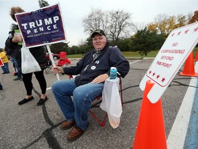 Elmer Courtney does some last minute campaigning outside of a polling station in the community of Trenton outside of Detroit on U.S. election day, Nov. 8, 2016.