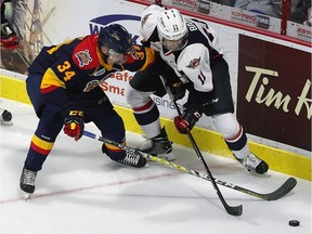 Mike Baird of the Windsor Spitfires battles for the puck with Jack Duff of the Erie Otters at the WFCU Centre in Windsor on Sept. 22, 2016.