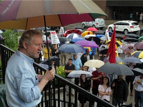 Brian Brown, left, president of the Canadian Association of University Teachers Defence Fund, addresses a large group of WUFA members July 8, 2014.