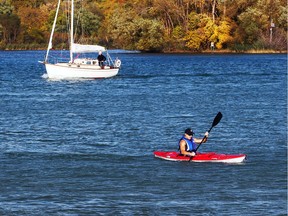 Evan Mascaro paddles his kayak across the Detroit River from Peche Island where he spent the afternoon walking trails on Nov. 1, 2016. Mascaro made his trip under ideal conditions with temperatures near record highs.