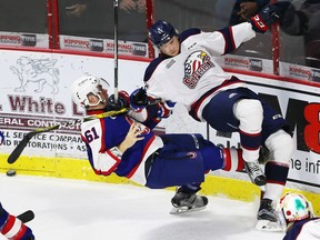 Windsor Spitfires Luke Boka collides with Saginaw Spirit Markus Niemelainen in OHL action from WFCU Centre in Windsor on Nov. 3, 2016.