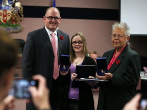 Mayor Drew Dilkens, left, poses with Sovereign's Medal for Volunteers recipients Jenna Hotham and Andrea Grimes, right, at City Council on Nov. 7, 2016. A national award, Sovereign's Medals are given by Gov. Gen. David Johnston.
