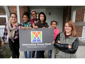 Mackenzie Kovaliz, right, is the co-ordinator of Advocating Young Minds drop-in program in the St. Joseph's Street housing neighbourhood.  Tamarah McKinney, 11, left, Elisha Back, 10, Elizabeth Back, 12, Dillon Norris, 13, and Janelle Hall, 10, enjoy their visit Tuesday, Nov. 8. 2016.