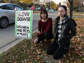 Haley Bould, 19, and her sister Heather Bould, 18, right, monitor motorists along the 1800 block of Balfour Boulevard on Nov. 15, 2016.