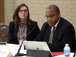 Hon. Justice Michael H. Tulloch, right, listens with counsel Danielle Robitaille during a roundtable discussion at Independent Police Oversight Review at the University of Windsor's Vanier Hall on Nov. 15, 2016.