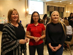 Dian Reko, president and CEO of Reko International Group Inc., left, speaks with  St. Joseph's Catholic High School students Sandra Hoang, 16, and Keileigh Robinson, 17, during the Junior Achievement South Western Ontario World of Choices event held at the Fogolar Furlan Club.