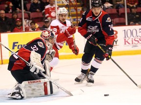 Windsor Spitfires Sean Day (74) looks to clear a loose puck in front of goalie Mario Culina and Soo Greyhounds centre David Miller during first-period OHL action on Nov. 30, 2016 at Essar Centre in Sault Ste. Marie, Ont.