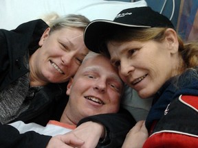 Conner Dufour is flanked by his mother Crista Dufour (left) and his grandmother Shelley Teixeira just before his surgery.