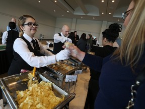 Kennedy Batten serves up a some potatoes during the 6th Annual Potatofest at the St. Clair Centre for the Arts in Windsor on Thursday, December 1, 2016. Money raised at the event goes towards In Honour of the Ones We Love. Organizers hope to raise $10,000.