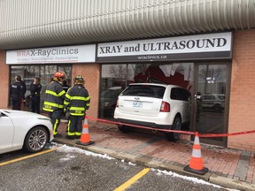 Firefighters on the scene after a Ford Edge slammed through the front window of a Walker Road medical clinic.