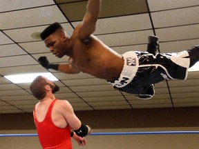 Can-Am Wrestling School graduate Sheldon Dean delivers a flying attack against fellow graduate Kurt Hendrik at Border City Wrestling's Christmas event in Tecumseh on Dec. 18, 2016.