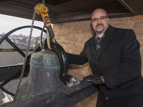 Rev. Canon Lance Smith is pictured with the newly re-conditioned church steeple bell at the Anglican Church of the Ascension, Friday, Dec. 23, 2016.