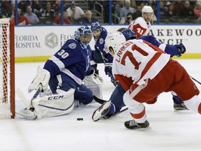 Tampa Bay Lightning goalie Ben Bishop (30) stretches to make the save on a shot by Detroit Red Wings centre Dylan Larkin (71) during the first period of an NHL hockey game on Dec. 20, 2016, in Tampa, Fla. Bishop left the game with an injury.