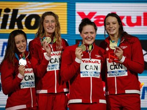 Taylor Ruck, Kennedy Goss and Penny Oleksiak celebrate their gold medal in the 4x200m freestyle at the FINA World Swimming Championships (25m) at the WFCU Centre on Dec. 10, 2016.