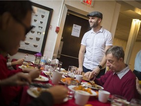 Ben Davidson, owner of the Green Bean Cafe, shares a laugh with a family enjoying a Christmas dinner at the cafe's annual Community Christmas Dinner, Sunday, Dec. 25, 2016.