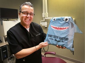 Dr. Domenico Aversa is promoting a new shark bag dental health initiative for kids. The program comes out of the city hall decision to ban fluoridation and direct the money saved to dental education programs. He poses with the bag at his Windsor  office on Dec. 6, 2016.
