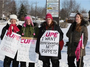 CUPE members Anita Johnson, left, Colleen Neumiller, Lori Wightman and Shannon McGuire walk the picket line at Essex County Library offices on Fairview Avenue on Dec. 19, 2016.
