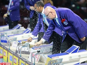 Officials give swimmers the bell lap notification during the women's 800m freestyle final at the 2016 FINA World Swimming Championships on Dec. 8, 2016, at the WFCU Centre in Windsor.