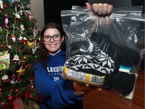 Rebecca Bell, 16, display a bag of toiletries, socks, winter wear, and snacks at her Windsor home on Dec. 19, 2016. She hands out dozens of the packages to homeless people in the community.