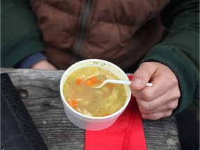 In this Dec. 22, 2013 file photo, a man eats a fresh cup of hot soup at the Making Smiles for the Homeless event at the former Greyhound bus depot in downtown Windsor.