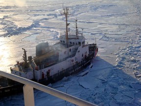 The crew of Coast Guard Cutter Neah Bay, homeported in Cleveland, Ohio works to keep the CSL Laurentien moving during an escort in eastern Lake Erie March 27, 2014. The crew experienced plate ice as thick as 3-feet and ice ridges and ice ridges up to 8-feet high.