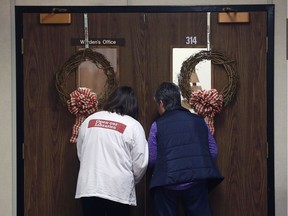 Striking Essex County library workers wait for library board members to exit an in-camera session at Essex County Civic Centre on Dec. 15, 2016.